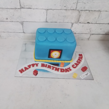Motivtorte blauer Legostein, wird die ganze Torte mit Fondant eingeschlagen und passend dekoriert.